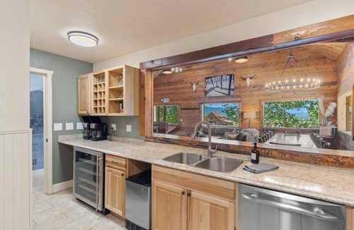 Clark Cabin | Spacious private king suite in the True North Adventure Lodge. Includes a king bed, private ensuite bathroom, and access to shared lodge amenities like the kitchen, great room, and hot tub. Ideal for couples or guests wanting extra space.